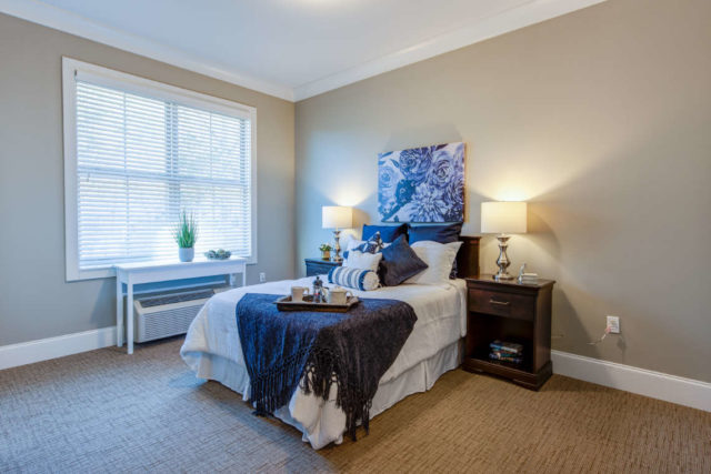 view of a bed in a private memory care room